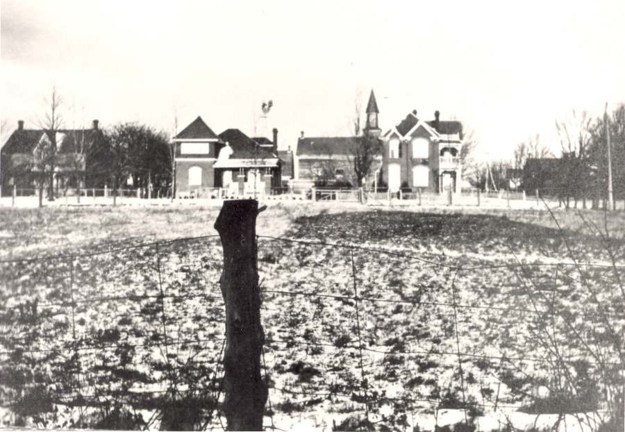 Image of Evangelical Church in Waterdown behind residences on John Street, black and white.